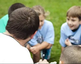 Coach talking to young athletes